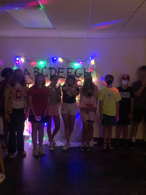 A group of tweens and teens pose in a Stranger Things escape room.